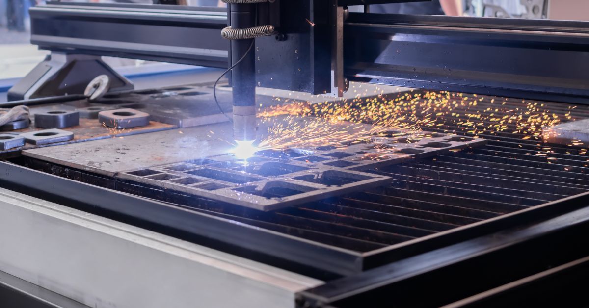 Plasma cutting machine cutting metal sheet in a precision machining shop